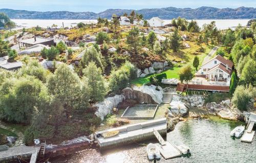 an aerial view of a house on a hill next to the water at Amazing Home In Fitjar With Wifi in Fitjar
