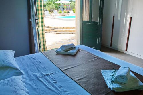 a bed with towels on it in a room with a pool at House Sweet Dreams in Pučišća