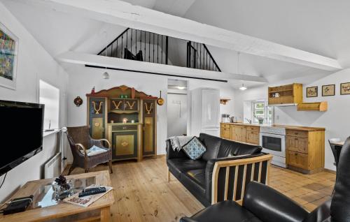 a living room with a couch and a table at 2 Bedroom Amazing Home In Blåvand in Blåvand