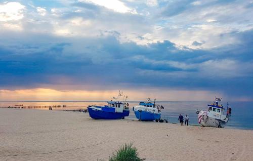 two boats sitting on the beach on a beach at Lovely Home In Mscice in Mścice