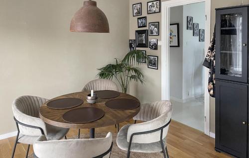 a dining room with a wooden table and chairs at Nice Home In Trosa With Wifi in Trosa