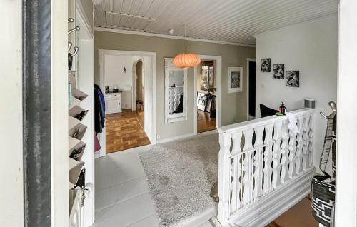 a hallway with a white staircase in a home at Nice Home In Trosa With Wifi in Trosa