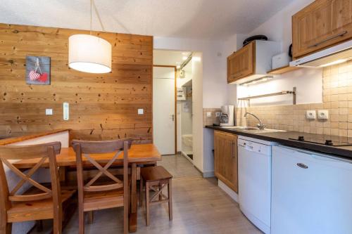une cuisine avec une table et des chaises dans une pièce dans l'établissement Résidence La Clef - Studio cabine pour 5 personnes de 26m² MAE-0701, à La Plagne Tarentaise