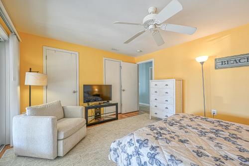 a bedroom with a bed and a chair and a ceiling fan at Straight to the Point in Bumpass