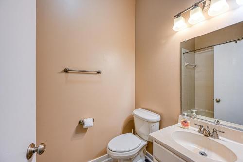 a bathroom with a toilet and a sink and a mirror at Straight to the Point in Bumpass