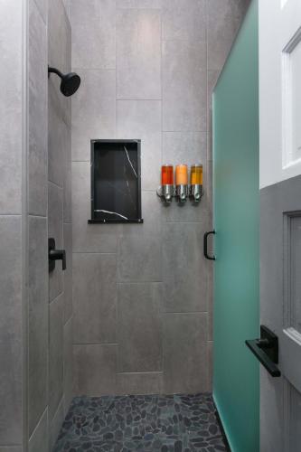 a bathroom with a shower with a television in it at La Ventana in San Diego