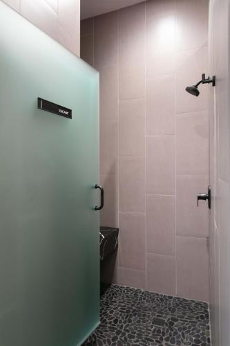 a bathroom with a shower with a glass door at La Ventana in San Diego