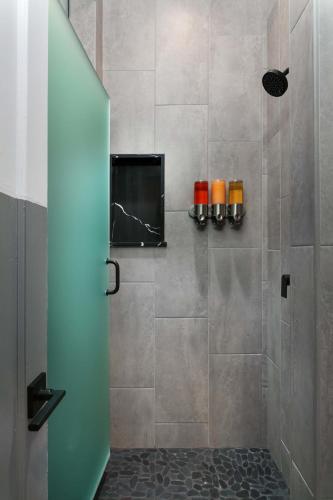 a bathroom with a shower with a television in it at La Ventana in San Diego