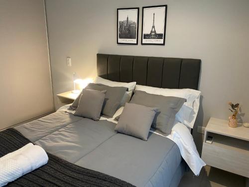 a bed with white sheets and pillows in a bedroom at Micro ensueño in Godoy Cruz