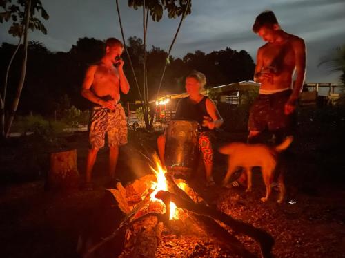 a group of people standing around a fire at Land of Promise - Reggae Escape in Zanderij