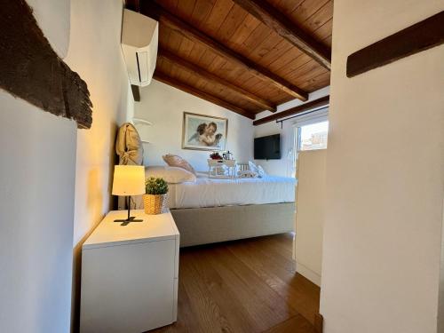 a bedroom with a bed and a table with a lamp at Pantheon Gabbianina Home in Rome