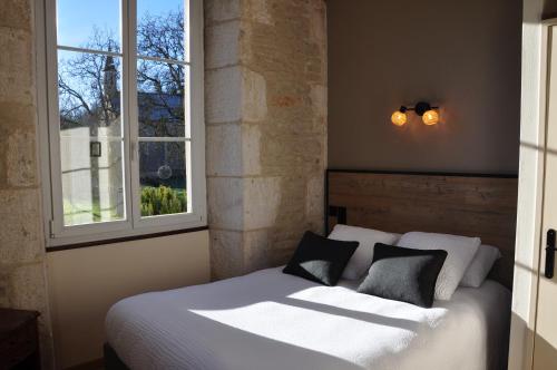 a bedroom with a white bed and two windows at Domaine Ferme Sainte Anne in Langres