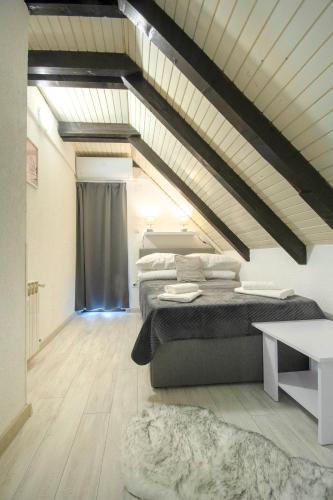 a attic room with two beds and a table at Edison,Plitvice Lakes in Jezerce