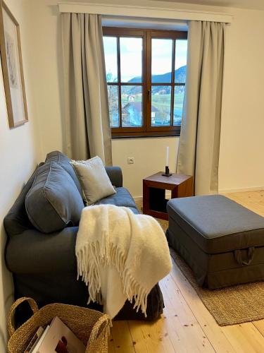 a living room with a couch and a window at Ferienwohnungen Lukaserhof in Mieming
