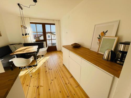a kitchen with a table and a dining room at Ferienwohnungen Lukaserhof in Mieming