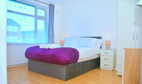 a bedroom with a large bed and a window at Time Space Bliss in Dagenham Dock