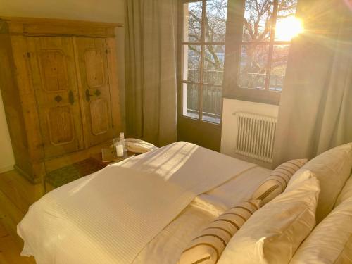 a bedroom with a large bed and a window at Ferienwohnungen Lukaserhof in Mieming
