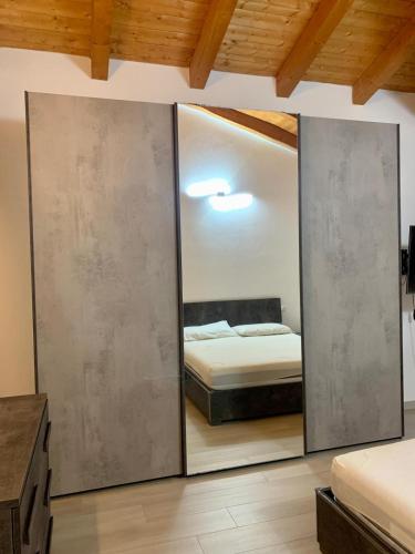 a bedroom with a mirror and a bed in it at Casa di Barbara in Piumazzo
