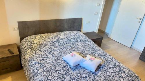 a bedroom with a bed with two pillows on it at Casa di Barbara in Piumazzo