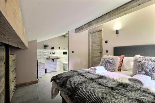 une chambre avec un grand lit et une salle de bain dans l'établissement Résidence 401 - Appartement Le 401 - Montriond centre MAE-1051, à Montriond