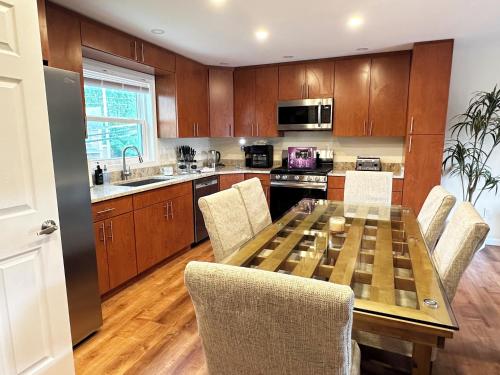 a kitchen with a wooden table and chairs at Saugerties Waterfront Getaway in Saugerties