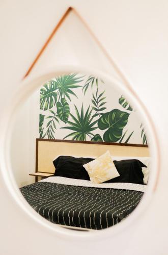 a mirror reflection of a bed in a bedroom at HayyaHayya Villas in Ocoy