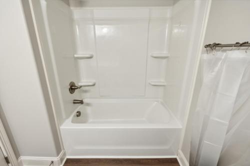 a white bathroom with a tub and a shower at Biltmore Luxury 1513 #5 Townhomes L 2bd 2 Bth in Clarksville