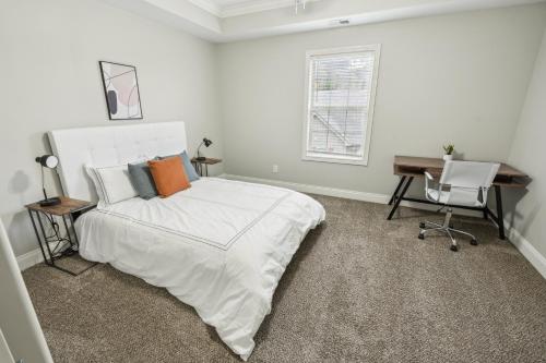 a bedroom with a bed and a desk and a window at Biltmore Luxury 1517 #2 Townhomes L 2bd 2 Bth in Clarksville