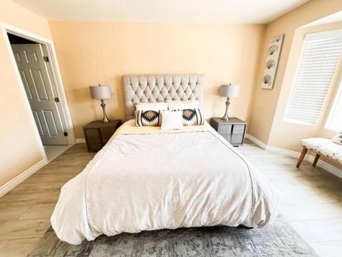 a bedroom with a large white bed with two lamps at Luxury Oasis in Central Encino w Pool & Spa Topeka in Los Angeles