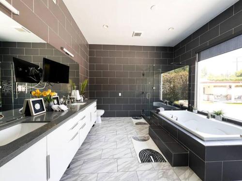 a large bathroom with a tub and a large window at Luxury Oasis in Central Encino w Pool & Spa Topeka in Los Angeles