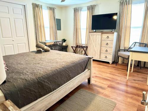 a bedroom with a bed and a flat screen tv at Saugerties Waterfront Getaway in Saugerties