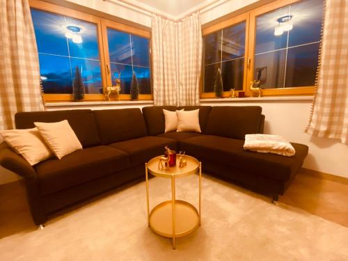 a living room with a couch and a table at Sonnalm Panoramablick in Rohrberg