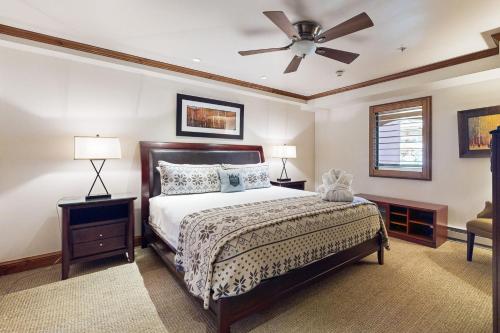 a bedroom with a bed and a ceiling fan at Lion Square Lodge North #392 & 394 in Vail