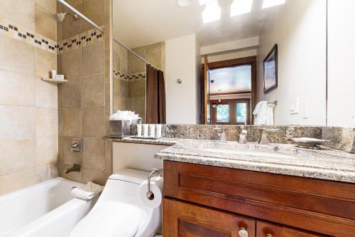 a bathroom with a sink and a tub and a toilet at Lion Square Lodge North #392 & 394 in Vail