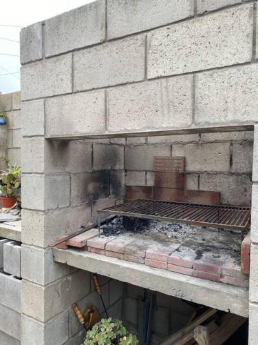a brick wall with a grill on top of it at Summer Haven MaR dEl PlAtA in Mar del Plata
