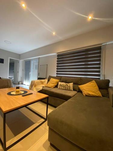 a living room with a couch and a coffee table at Summer Haven MaR dEl PlAtA in Mar del Plata