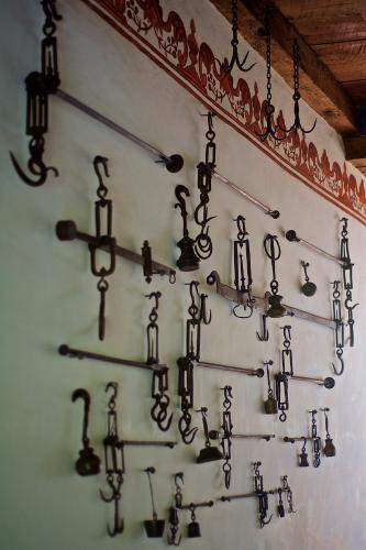 a wall filled with lots of different types of tools at Casa de la Real Aduana Boutique Hotel in Pátzcuaro