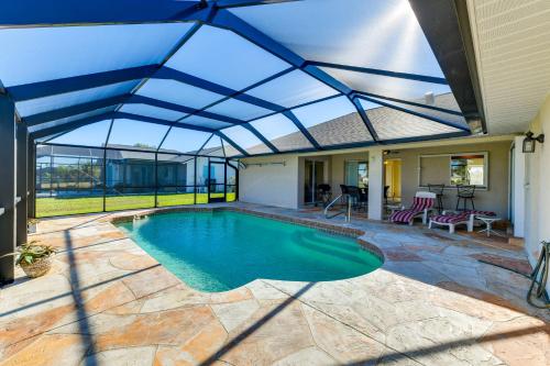an indoor swimming pool with a retractable roof at Canal-Front Home in Rotonda West Near Golf and Beach in Rotunda-West