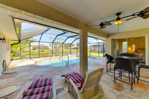 a patio with a pool and a table and chairs at Canal-Front Home in Rotonda West Near Golf and Beach in Rotunda-West