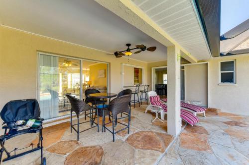 a porch with chairs and a table on a patio at Canal-Front Home in Rotonda West Near Golf and Beach in Rotunda-West