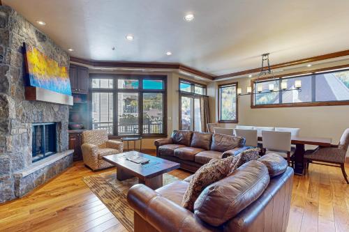 a living room with a couch and a fireplace at Lion Square Lodge Tower T401 in Vail