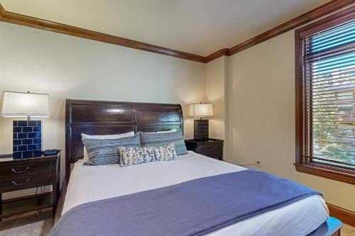 a bedroom with a large bed and a window at Lion Square Lodge Tower T401 in Vail