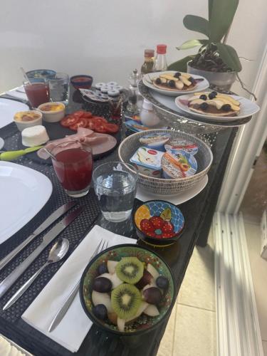 a table with many plates of food on it at Escape to St Julians in St Julian's