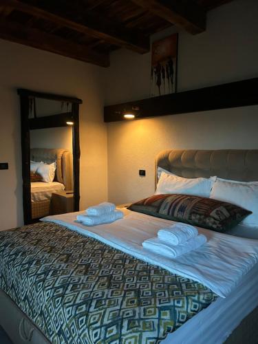 a bedroom with a large bed with towels on it at Pensiunea Lorena in Bran