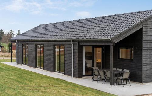 a black house with a table and chairs at 4 Bedroom Stunning Home In Haderslev in Haderslev