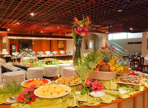 a buffet of food on a table in a restaurant at Jalsa Beach Hotel & Spa in Poste Lafayette