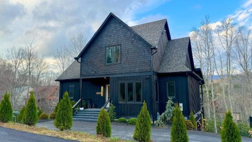 a black house with a black roof at Maynard V at Elk Creek in Banner Elk