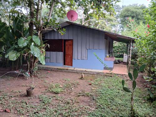 a small blue building with a red door at Casa Osa Bella John's house in Agujas