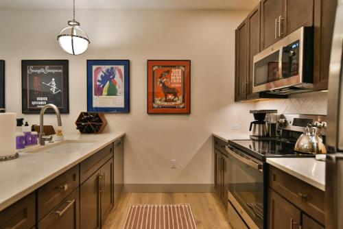 a kitchen with a sink and a counter top at Skywalk Flats Amphitheater Retreat: Downtown, Hot Tubs in Silverthorne