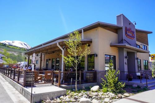 a restaurant with tables and chairs outside of it at Skywalk Flats Amphitheater Retreat: Downtown, Hot Tubs in Silverthorne